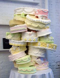 a large stack of baby diapers sitting on top of a white cloth covered table