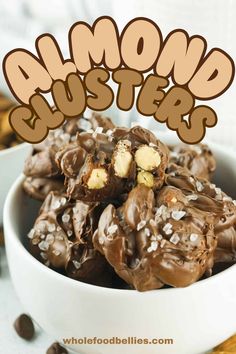 a bowl full of chocolate covered almond clusters with the words almond busters above it