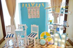 a room filled with lots of furniture and decor on top of a hard wood floor