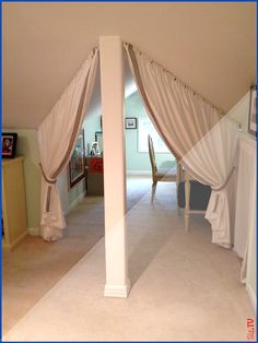 an image of the inside of a room with curtains on either side of the door