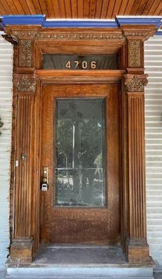 the front door to an old building with columns and numbers on it's sides