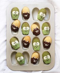 the cupcakes are decorated with green and brown icing, eyes and noses