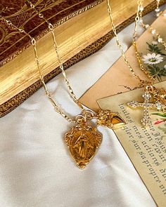 The My Madonna Necklace is a special reminder the lady Madonna is with you always. She a beautiful 18kt gold plated silver pendant 17x27mm. and gold plated silver heart pendant. Worn on a 18kt gold filled chain 20 inches long. Gold Plated Spiritual Necklace As Gift For Her, Spiritual Gold Plated Necklaces As Gift For Her, Tarnish Resistant Necklace For Mom, Gold Charm Necklace, Tarnish Resistant, Gift For Mom, Gold Oval Pendant Charm Necklace For Anniversary, Gold Tarnish Resistant Charm Necklace For Mom, Gold Oval Pendant Jewelry Gift For Her, Gold Tarnish-resistant Charm Necklace As Gift For Mom, Gold Clavicle Charm Necklace For Mom