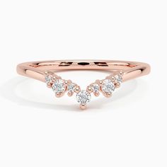 a rose gold ring with three diamonds