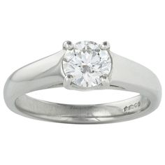 a white gold ring with a diamond in the center