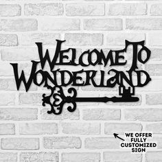 a welcome sign on a brick wall with the words welcome to wonderland written in black