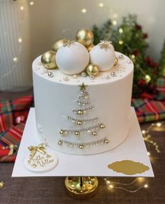 a white cake with gold ornaments on top