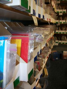 stacks of files and folders on shelves in a storage room