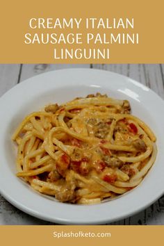 creamy italian sausage palamii linguini on a white plate with text overlay