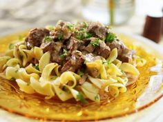 pasta with meat and sauce on a yellow plate