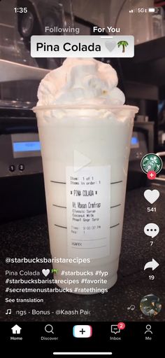 a cup filled with whipped cream sitting on top of a counter