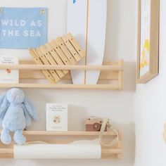 there is a stuffed animal and other items on the shelves in this nursery room,