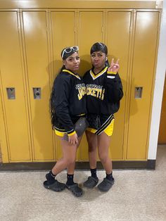 two girls standing next to each other in front of lockers