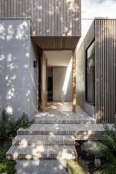 an entry way with steps leading up to the house