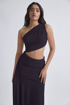 Dark grey malai lycra and net ruched one-shoulder dress with an asymmetric hemline, side cut-out and flared detailing. - Aza Fashions Ruched Pre-draped Asymmetrical Dress, Ruched Pre-draped Asymmetrical Dress For Night Out, Ruched Asymmetrical Dress For Evening With Asymmetrical Neckline, Pre-draped Ruched Asymmetrical Dress, Evening Asymmetrical Dress With Ruched Detail, Stretch Evening Dresses With Asymmetrical Skirt, Evening Dresses With Stretch And Asymmetrical Skirt, Evening Dresses With Asymmetrical Stretch Skirt, Ruched One Shoulder Dress With Asymmetrical Neckline For Gala