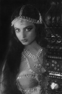 an image of a woman in costume with gold jewelry on her head and long hair