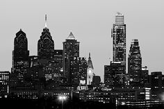 black and white photograph of the city skyline at night with skyscrapers in the background