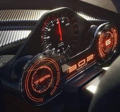 the interior of a car with illuminated gauges