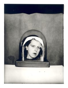 a black and white photo of a woman's face in a mirror with her eyes open