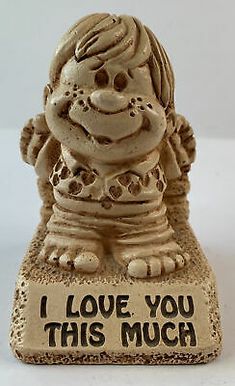 a ceramic figurine with the words i love you, this much on it