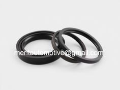 two black rubber rings on a white surface