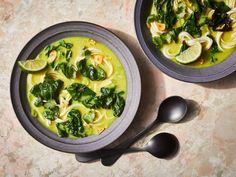 two bowls of soup with spinach and noodles