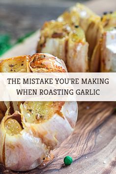 some food that is sitting on top of a wooden cutting board with the words, the mistke you're making when roasting garlic