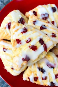 cranberry scones with icing on a red plate