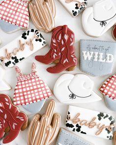 some cookies are decorated with cowboy boots and plaid shirts on them, along with the words wild