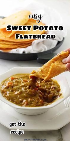 a person dipping tortilla chips into a bowl of sweet potato flatbread soup