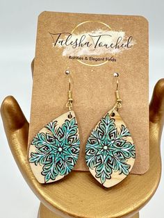 Get ready to step out in style with these beautiful Snowflake Earrings that have been cut from maple wood, deeply engraved and hand painted by me. This listing is for one pair of earrings. The snowflakes are painted in a bluish / Turquoise color and highlighted with white. The perfect gift for yourself, someone you love or co-worker.Each set of earrings will come beautifully packaged for gift giving. Made with nickel free gold tone ear wires and findings.  The perfect gift for any age and the pe Painted Wood Art, Christmas Tattoo, Style Snow, Laser Cut Wood Earrings, Wood Painting Art, Winter Jewelry, Snowflake Earrings, Wood Burning Art, Jewelry Christmas