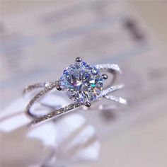 a diamond ring sitting on top of a table