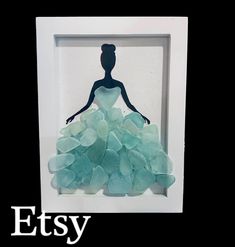 Now by special order. Will be very similar to this one. I send a photo before I mail. Aqua sea glass silhouette lady with aqua sea glass gown that flows out onto the wooden frame.   Perfect for wedding, engagement, birthday, dancer or evening gala  Little girls room decor  Black silhouette on canvas in shadow box frame. 3D effect with Layers upon layers of surf tumbled sea glass. Bodice has a piece of heart-shaped sea glass  Layers and layers of glass. Sea side view  Approx 6x8 inches  Can display on desktop or wall 3d Silhouette, Silhouette Shadow, Broken Glass Crafts, Sea Glass Heart, Sea Glass Diy, Sea Glass Artwork, Sea Glass Art Diy, Sea Glass Art Projects, Heart 3d