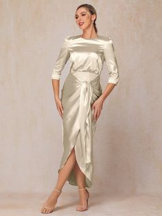 a woman is wearing a dress with a slit down the side and an asymmetric wrap