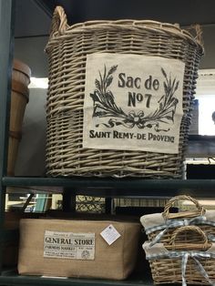 baskets are stacked on top of each other in front of a sign that reads sac de no 7 saint remy - de - proven