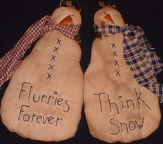 two snowmen with words written on them sitting next to each other in the shape of mittens