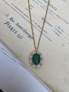 Gold-plated over brass vintage inspired pendant with crystals and a large oval emerald green measuring 2.4 cm 3 cm. Hung on a gold-plated over stainless steel twisted chain measuring 18 inches. Comes in a black velvet cushioned box as seen in last photo. Free of charge. INTERNATIONAL BUYERS please choose the tracking option if you would like your order to be tracked. FREE tracking upgrade with 3 items or more purchased. JEWELLERY CARE please don't wear plated jewellery in the shower, bath or swi Emerald Necklace Vintage, Luxury Oval Pendant Emerald Necklace, Vintage Gold Crystal Necklace, Vintage Emerald Necklace As A Gift, Vintage Emerald Necklace Gift, Vintage Gold Plated Necklace With Oval Pendant, Vintage Emerald Necklace For Gift, Vintage Gold Emerald Necklace For Formal Occasions, Vintage Gold Necklace With Emerald