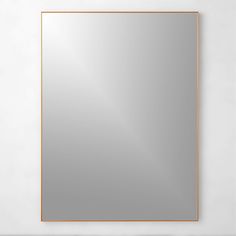 a square mirror hanging on the wall