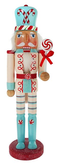 a wooden nutcracker figurine holding a candy cane