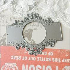 there is a silver frame on top of a card