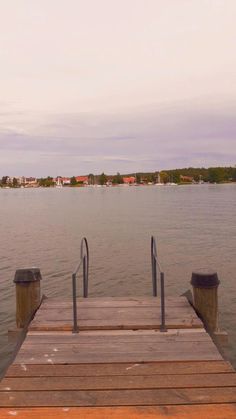 a wooden dock sitting on top of a large body of water