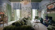 a living room filled with furniture and a chandelier