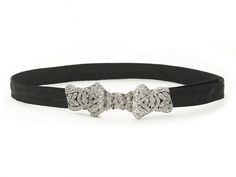 An Art Deco diamond set platinum bow choker, with an old-cut diamond set plaque, in the form of a bow, mounted in platinum, on a black moiré ribbon choker, with an estimated total diamond weight of 1.50ct, circa 1930. Period: Circa 1930 Style: Art Deco Metal: Platinum Stone: Diamond Approximate Measurements: Plaque 68mm, Choker 68cm Condition: Good - Wear consistent with age and use Approximate Weight: 14.2 grams Formal Black Ribbon Choker Jewelry, Elegant Evening Jewelry With Black Ribbon, Elegant Adjustable Jewelry With Black Ribbon, Formal Black Jewelry With Black Ribbon, Black Ribbon Choker, 1930's Style, Bow Choker, Ribbon Choker, Diamond Choker