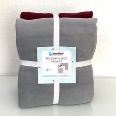 a gray and red pillow with a white ribbon around it's edge that says no - sew fleece