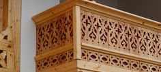 an ornate wooden balcony railing with decorative carvings on the balconies and side panels