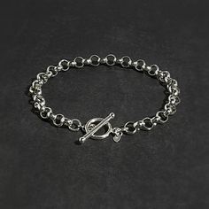 "Enhance your style with this elegant sterling silver rolo tag bracelet. Boasting a 6.3mm rolo bracelet and classic design, this bracelet is minimal yet bold.  Details: Chain: Sterling Silver Rolo Chain, 6.3mm Clasp: Sterling Silver Toggle Clasp Sizes: 6\" to 9\"  Full and half sizes Shipping: Ready to ship within one business day Complimentary shipping in the USA Complimentary gift wrap Matching Necklaces: https://lagunalifedesigns.etsy.com" Silver Chain Style, Toggle Bracelet, Personalized Bracelets, Design Minimal, Rolo Chain, Matching Necklaces, Toggle Clasp, Chain Link Bracelet, Chain Styles