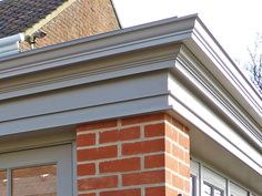 an image of a bird sitting on the roof of a house