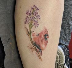 a bird and flower tattoo on the arm