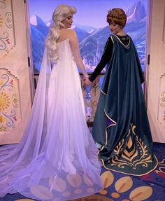 there are two women dressed up as princesses and one is wearing a wedding dress