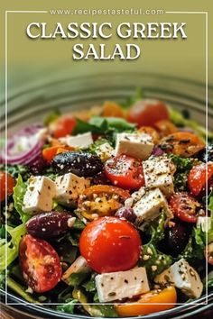 a close up of a salad with tomatoes, olives and feta cheese on it